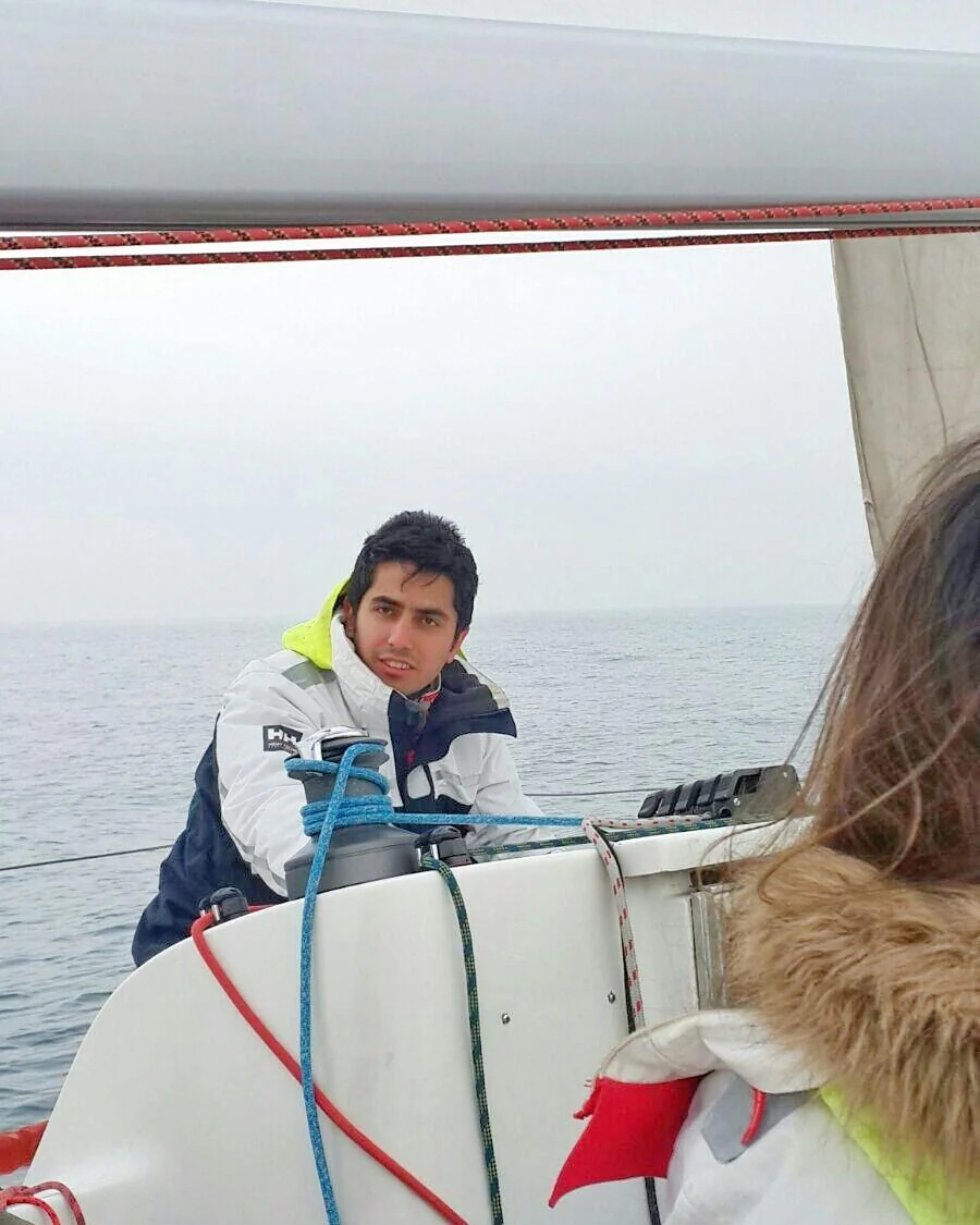 A photo of me at the helm, from my sailing post.